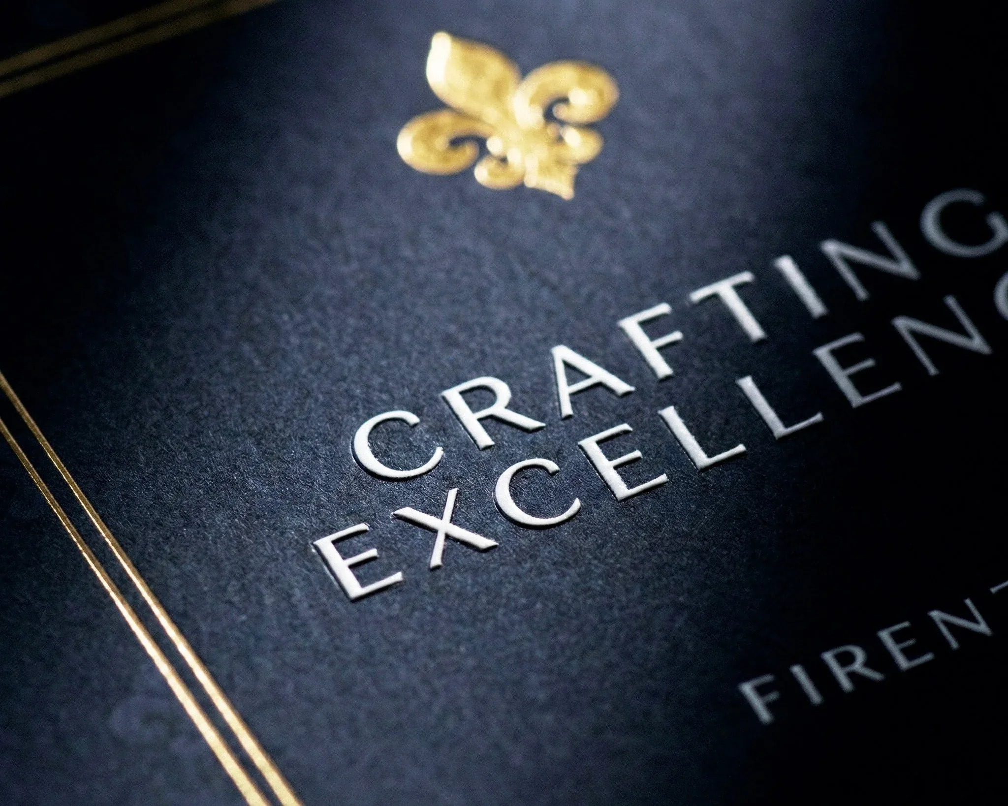 Dettaglio della copertina blu notte del libro Crafting Excellence. Firenze. con il giglio dorato e il titolo in rilievo: progetto editoriale